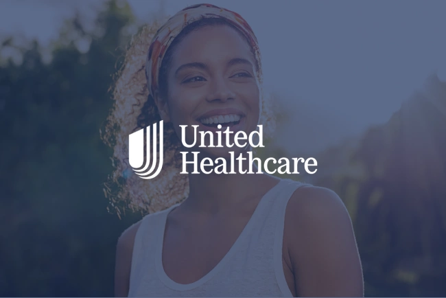 Woman wearing white tank top and headwrap smiling outdoors with forest background and United Healthcare logo overlay.